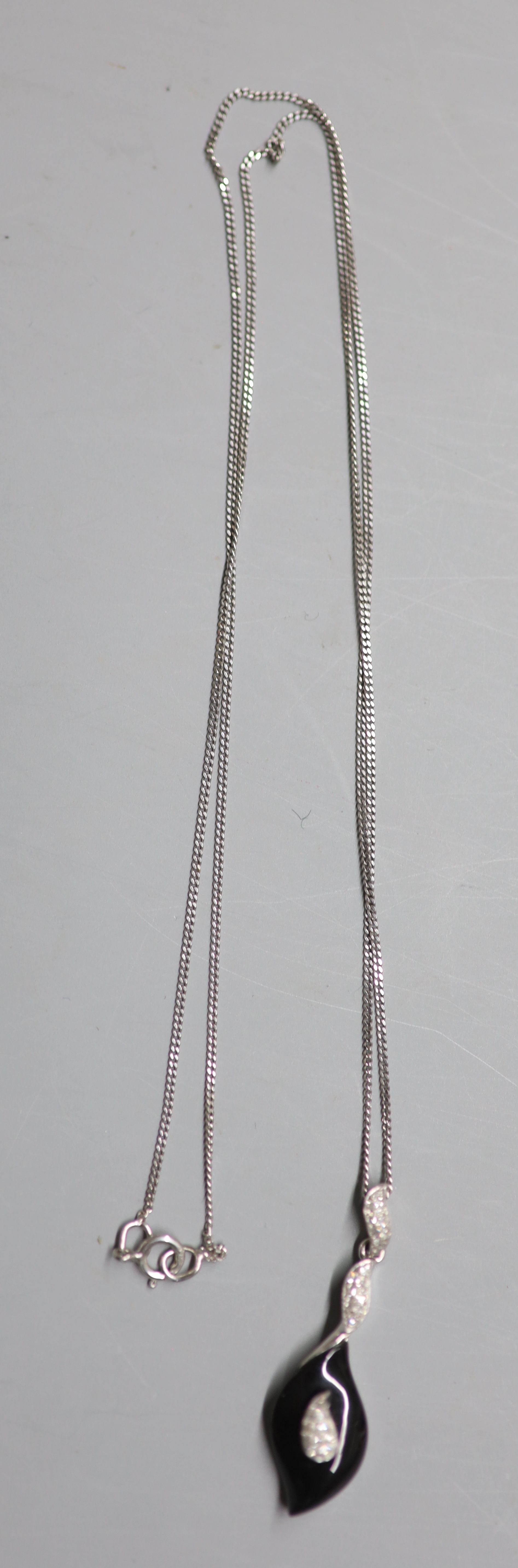 A modern 9ct white gold, black onyx and diamond chip set drop pendant, 31mm, on a 9ct white gold fine link chain